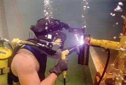 A person welds underwater.