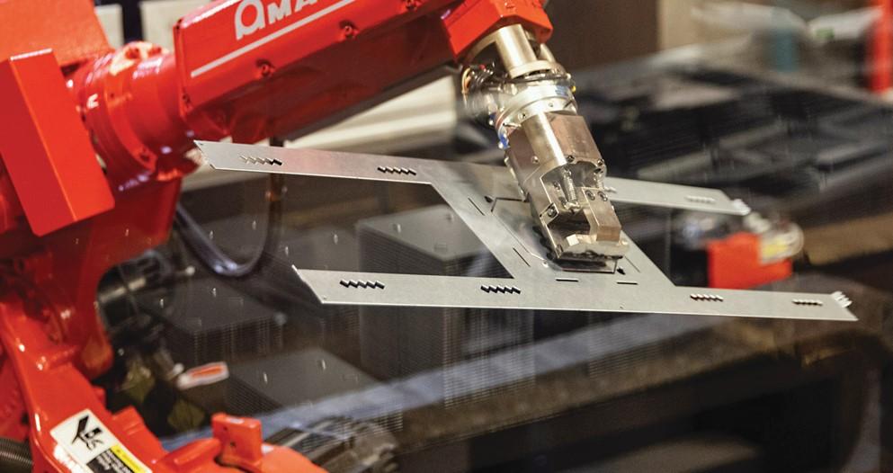 A bending robot holds a bracket.