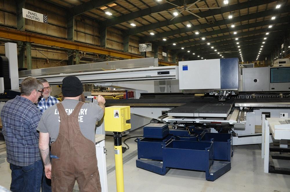 An employee operates a TRUMPF punch/laser combination machine.