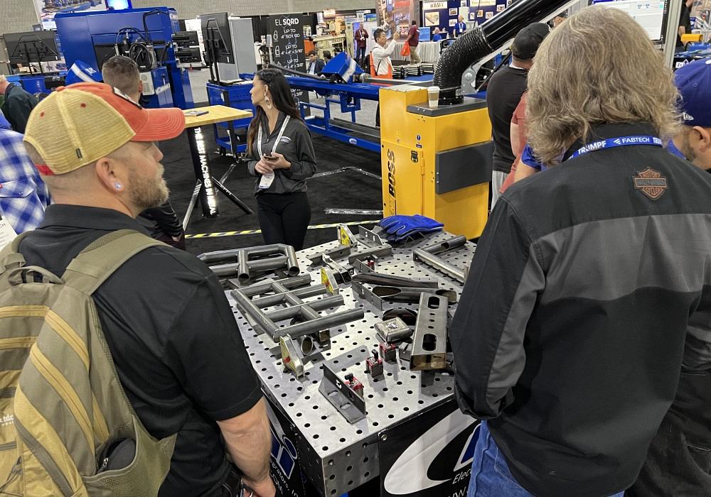 FABTECH 2022 attendees looking at metal parts