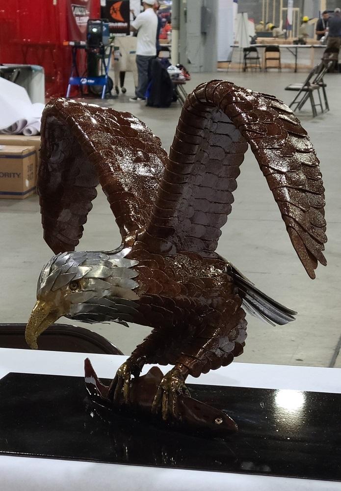 An welded metal eagle sculpture is on display.