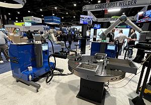 trip hammer blacksmith A cobot with a spot welding machine attached to it engages with parts on a rotary table.