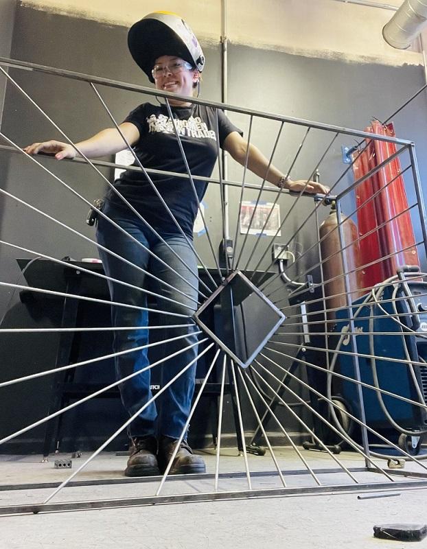 Guzmán poses with a metal project.