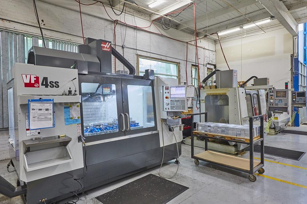A Haas machining center is shown.