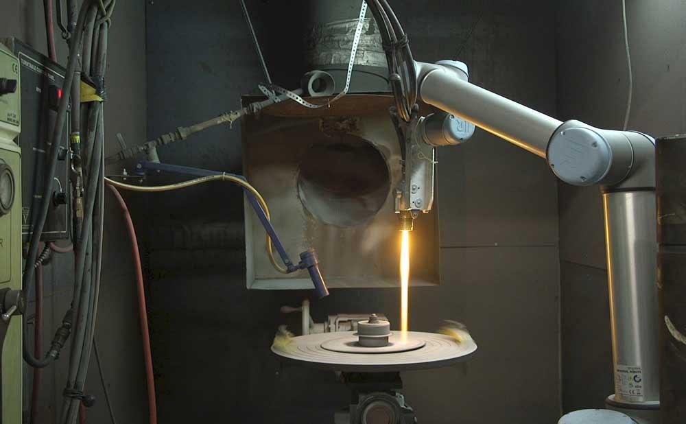 collaborative robot performs a thermal spray operation