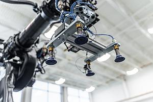 part presentation manufacturing A robot with grippers in shown.