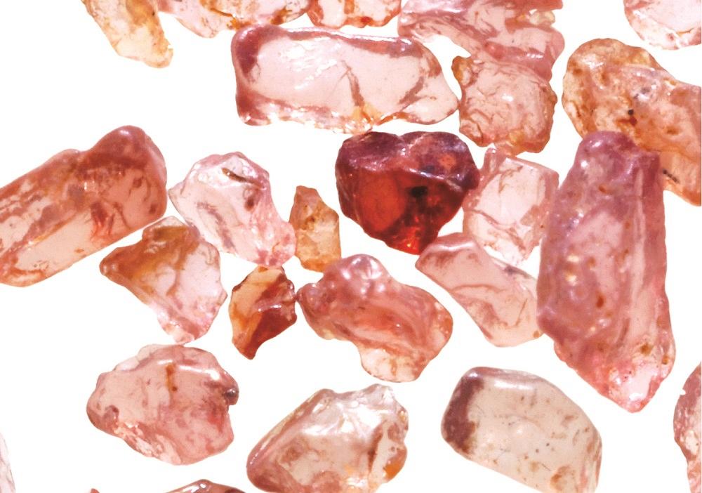 A detailed view reveals the smooth edges of alluvial garnet abrasive.