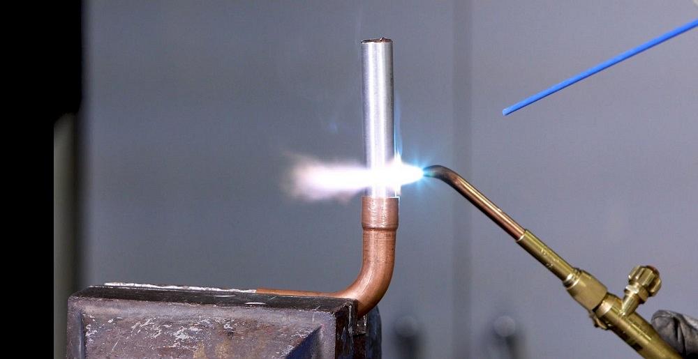 A tube is heated with a torch. 