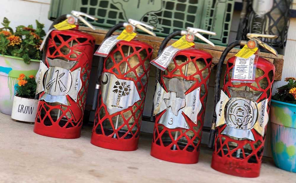 fire extinguishers made into custom metal art by rae ripple