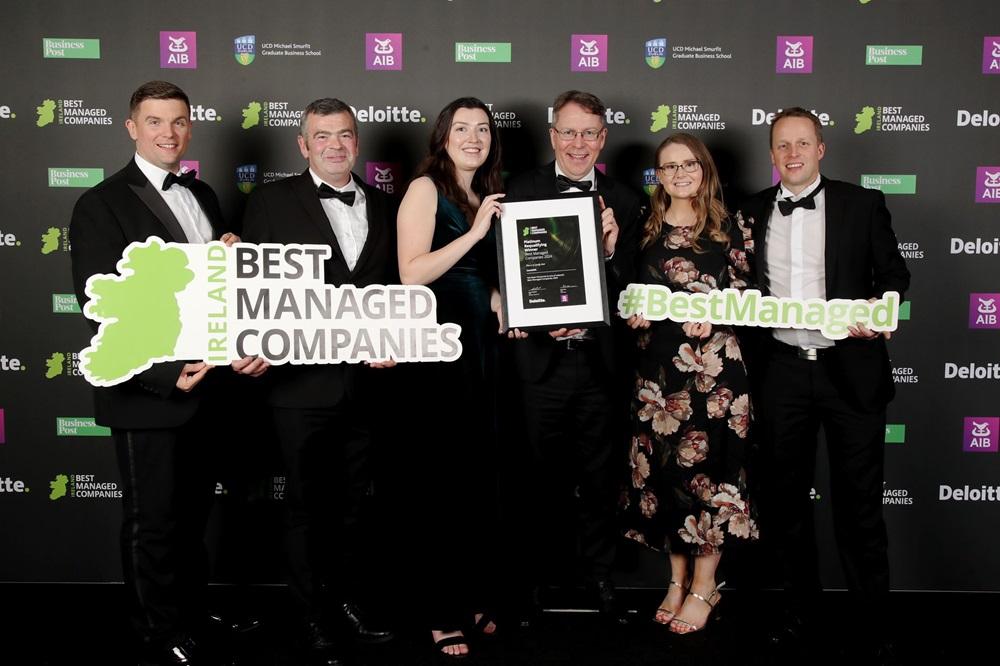 Six people hold a Best Managed Companies sign