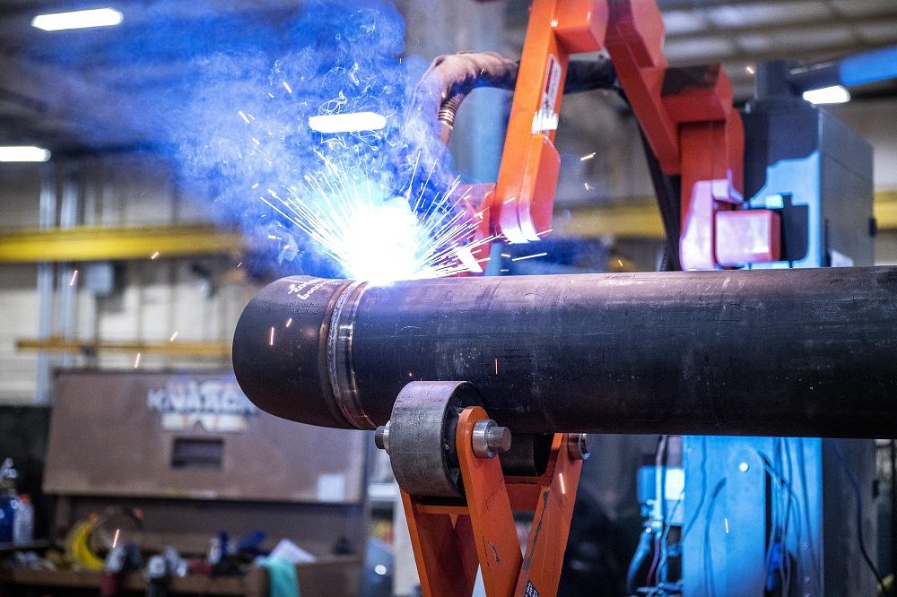 Automated technology using a rotary pipe welding cell in a metal fabrication shop