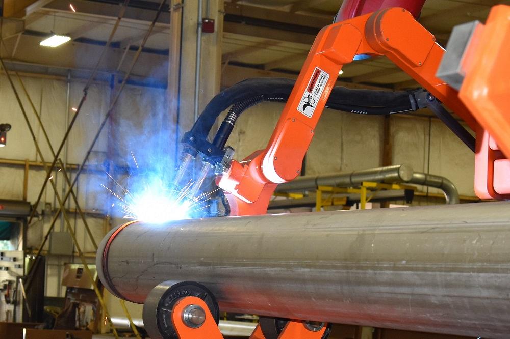 Automated technology using a rotary pipe welding cell in a metal fabrication shop