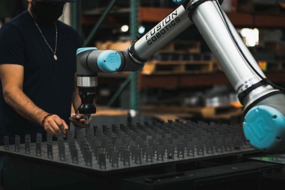 A collaborative robot is used to help with assembly.
