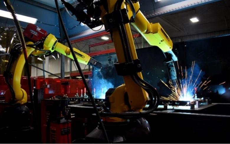 Two robots perform welding tasks. 