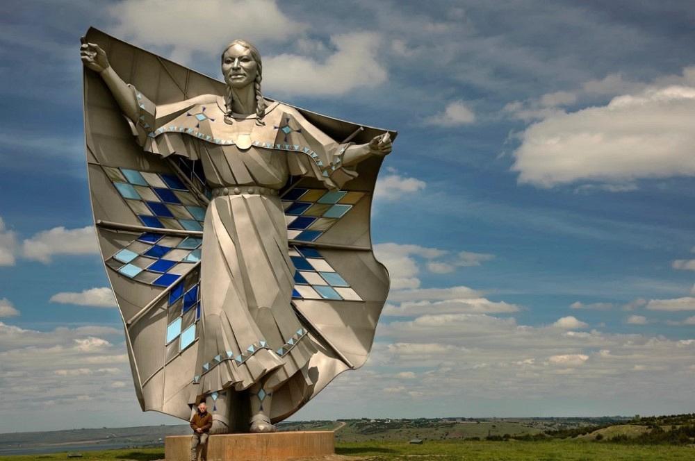 A stainless steel sculpture of a Native American woman.