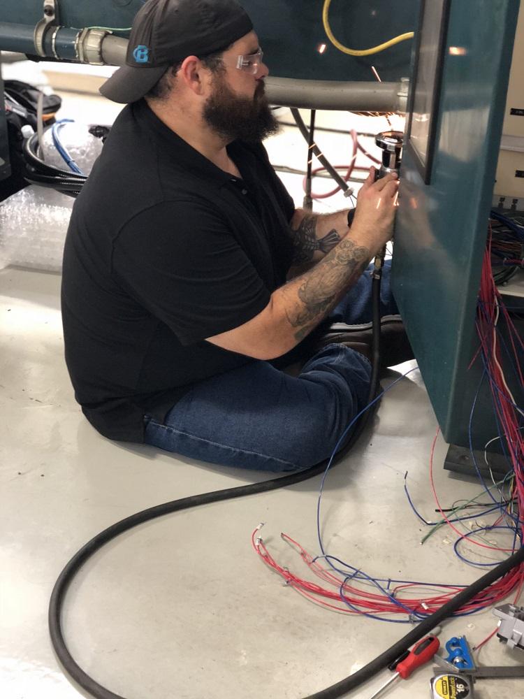 Machine repairman fixing a tube bender 
