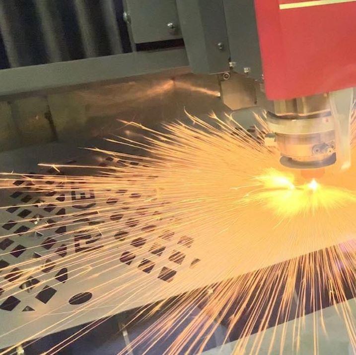 A laser cuts sheet metal parts.