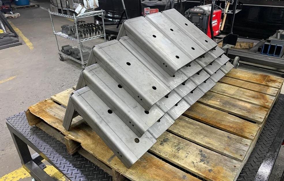 Formed metal parts sit on a pallet.