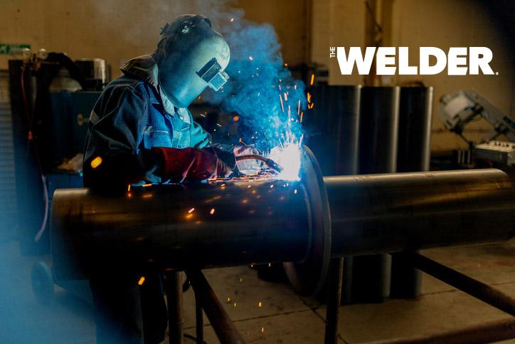 A welder MIG welds a pipe fabrication.