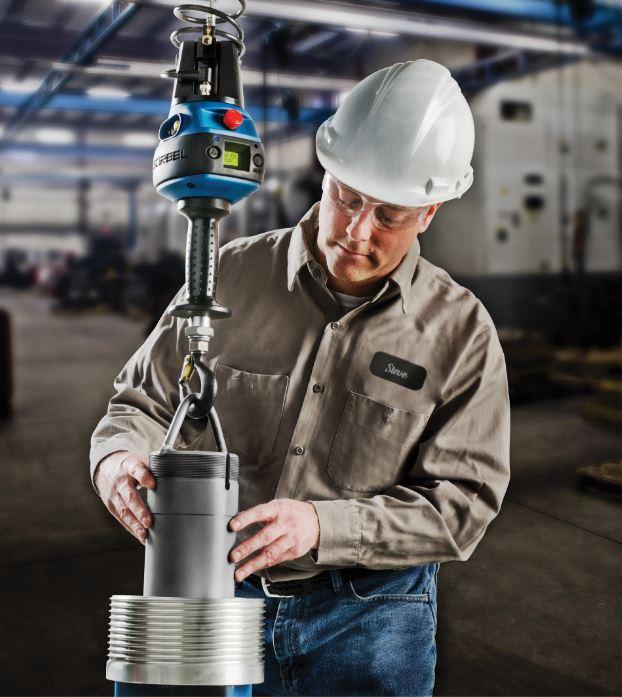 A lifting device helps workers move heavy loads.