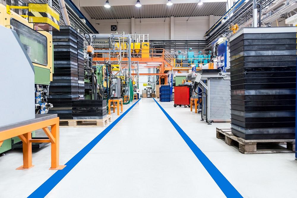 An aisle in a manufacturing facility is free of work-in-process.