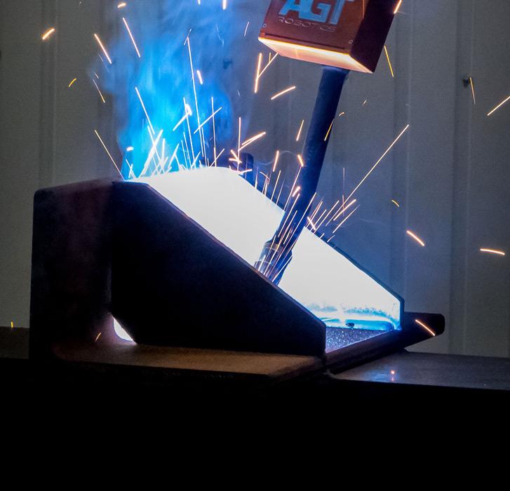 A robot welds a structural flange