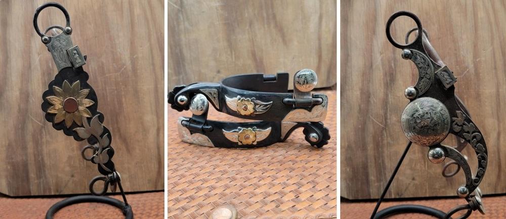 Horse bits and cowboy spurs are displayed on a table.
