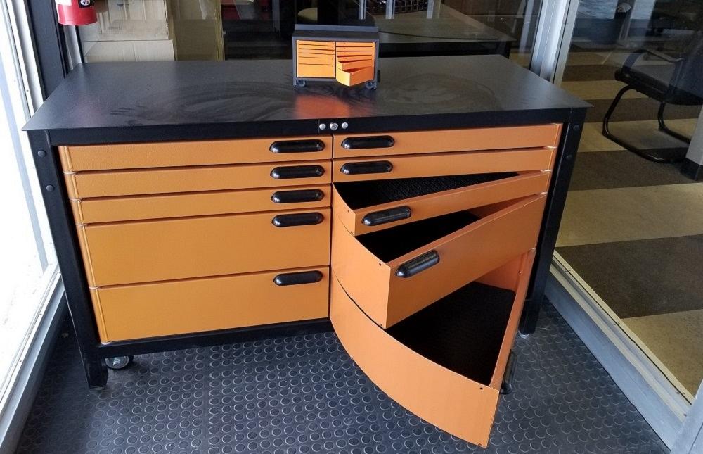 A cabinet with swivel-style drawers is shown.