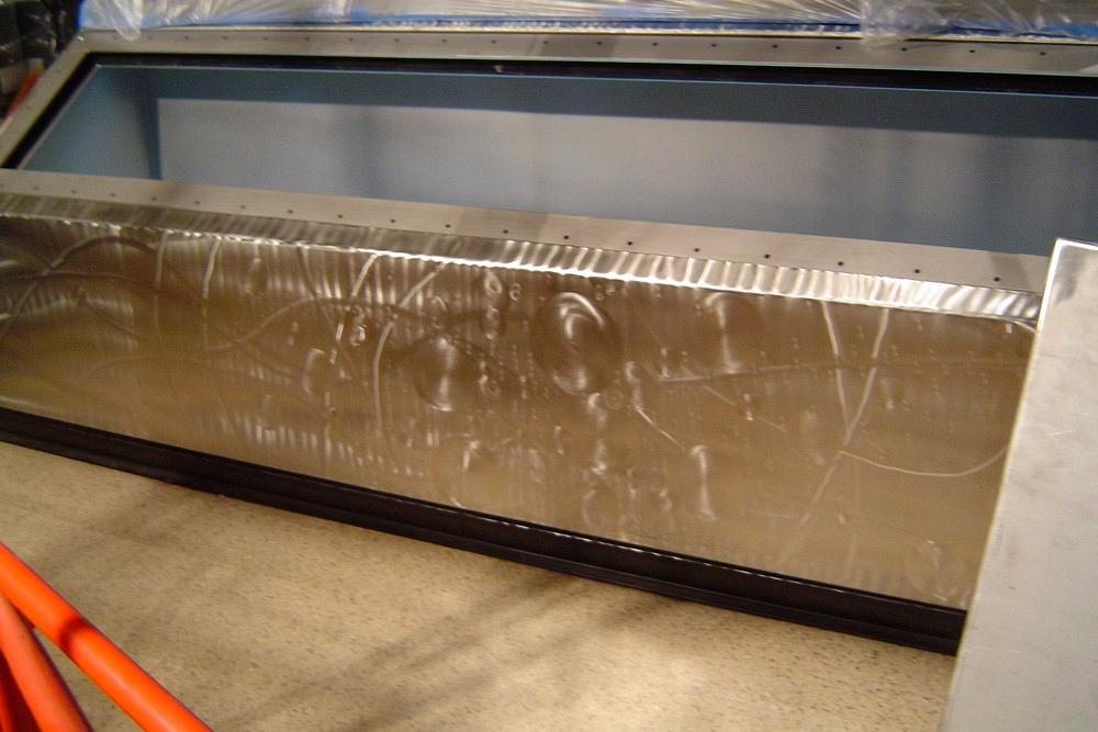 This display case for a female giant squid has a specialty finish on its stainless steel surface.