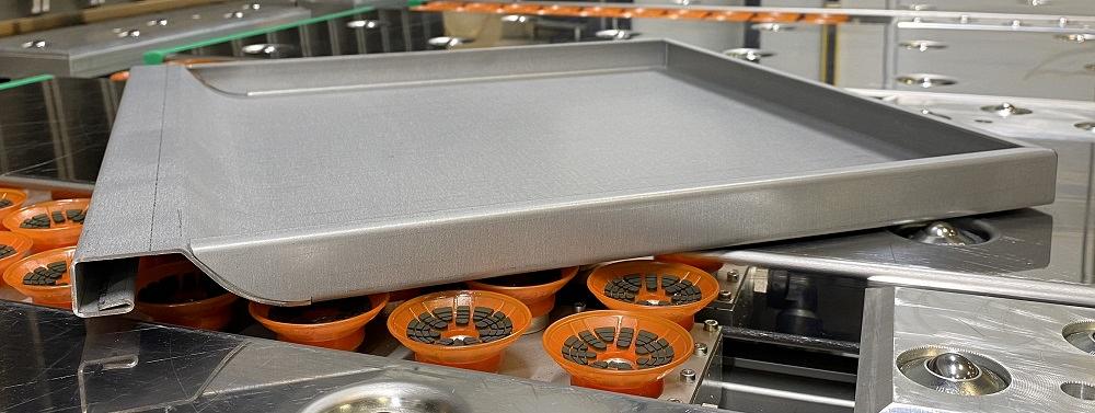 A drawer front formed on a folding machine is shown.