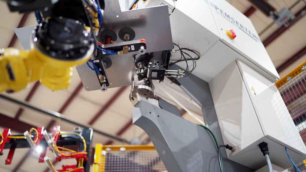 robot inserts hardware into sheet metal