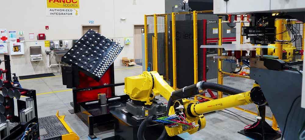 An alignment table in a robot cell for sheet metal fabrication