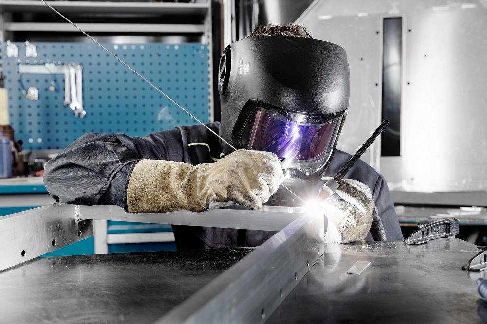 Welder wearing 3M equipment and working in a metal fabrication shop