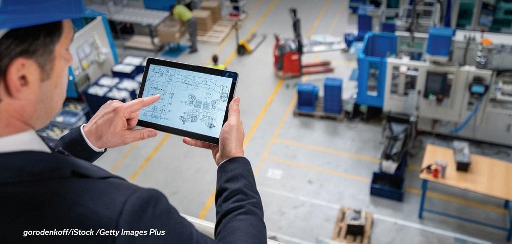 manufacturing plant manager using tablet to track business data