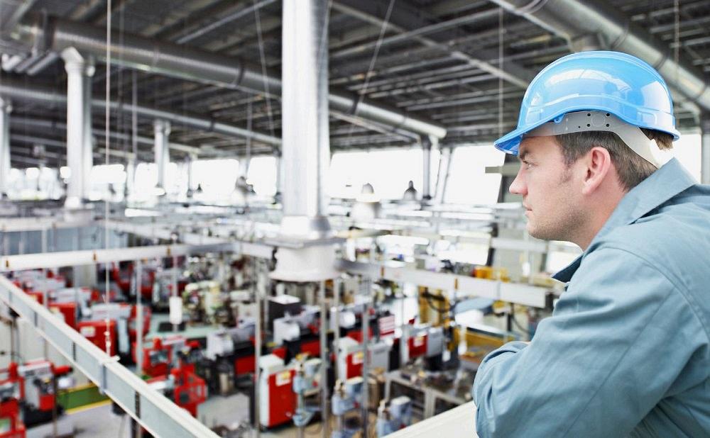 manufacturing plant manager looking over a shop floor