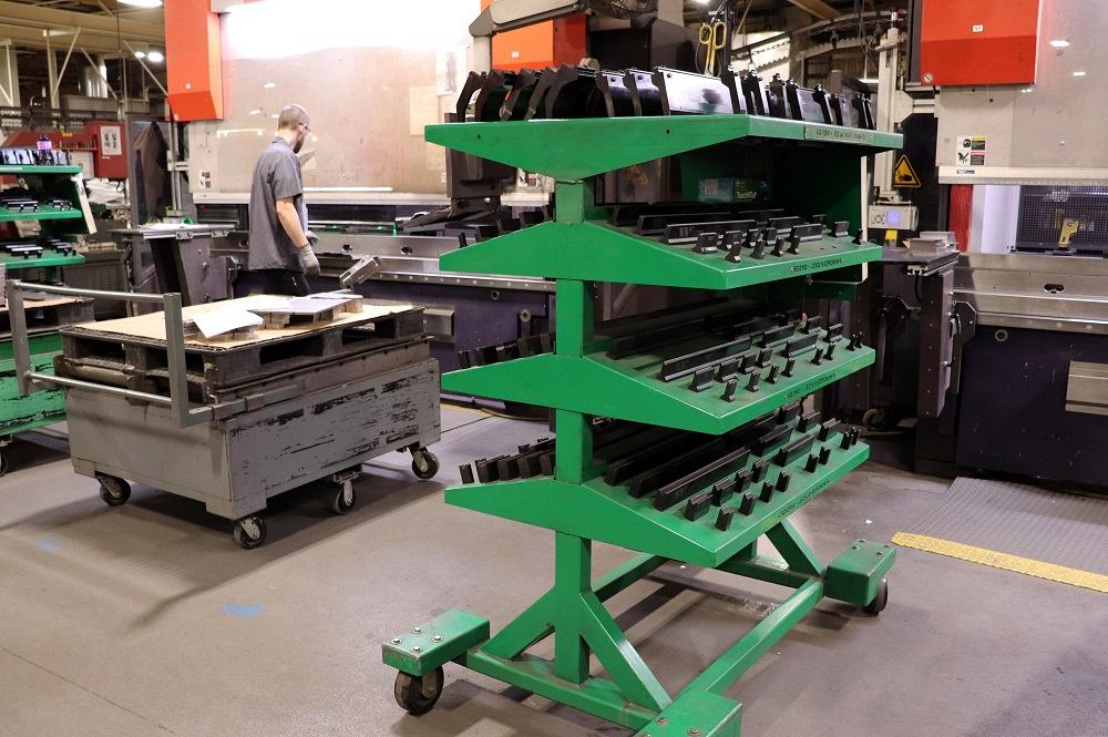 A rack with press brake tooling is shown.