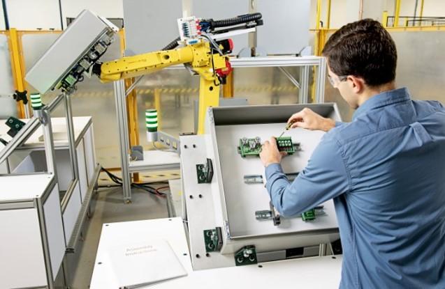 An assembler works safely near a robot