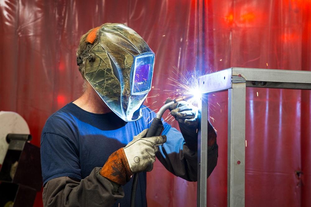 A welder works on a frame.
