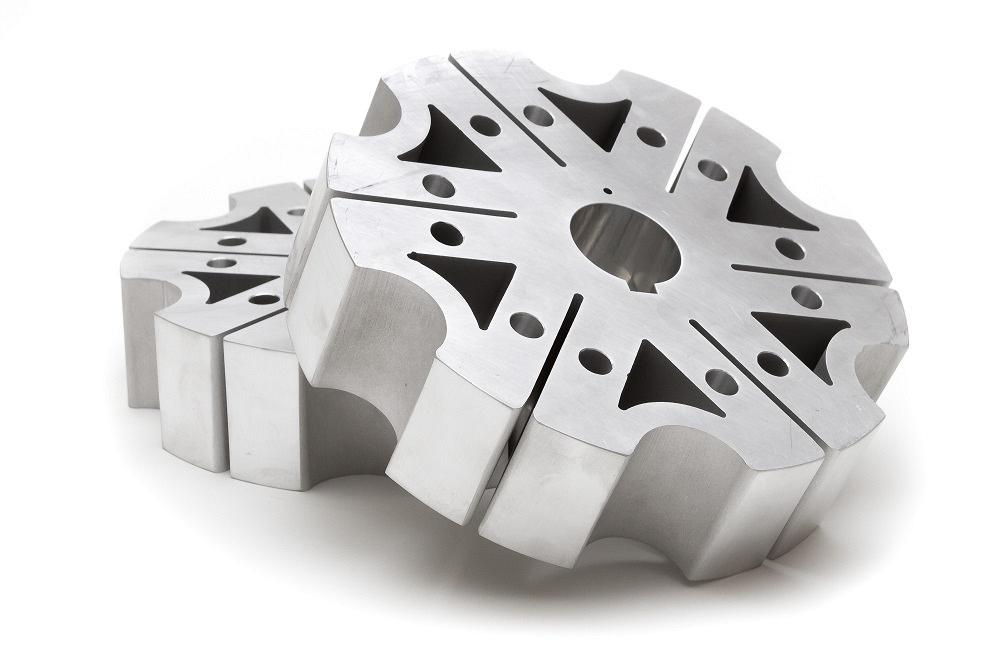 A waterjet-cut aluminum part with intricate features is shown.