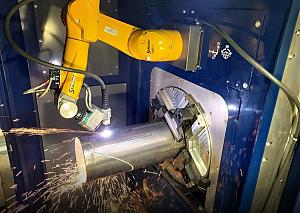 part presentation & lean manufacturing A robot plasma cuts a metal tube.