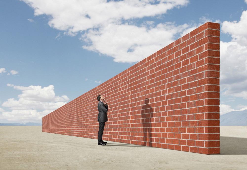 Illustration of man standing behind a wall