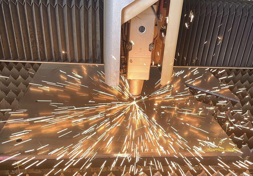 A laser cuts sheet metal.