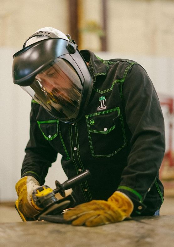 A man inspects a welded part.