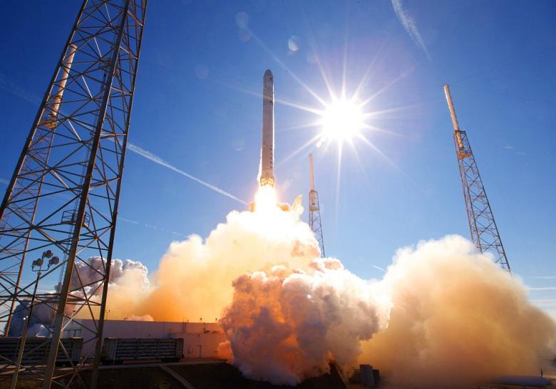 A Falcon 9 launch vehicle lifts off with a Dragon spacecraft aboard.