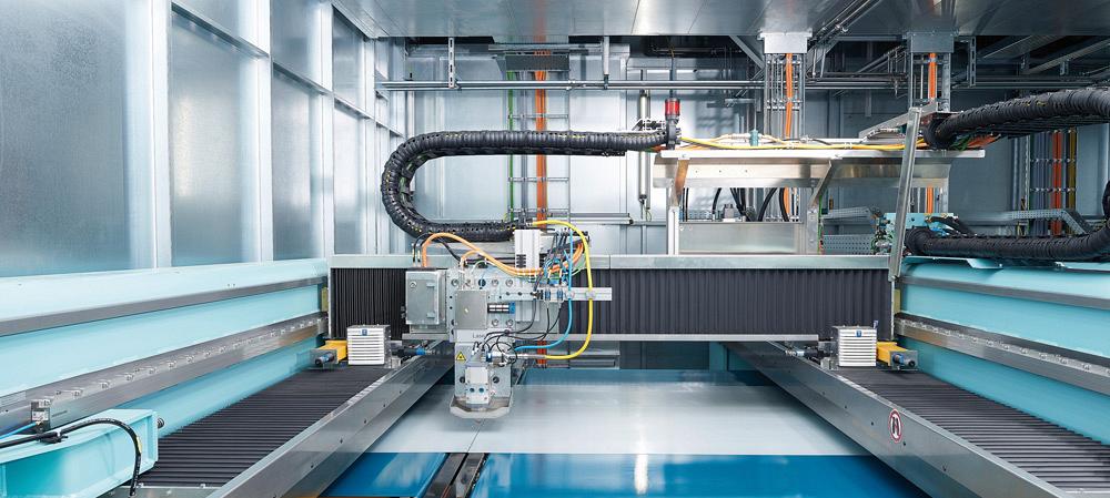 A Schuler laser blanking machine cuts a moving metal strip at a Daimler plant
