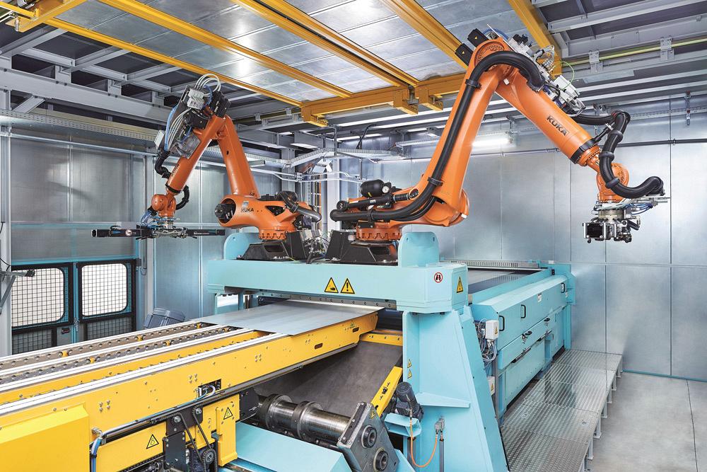 Robots remove parts from a Schuler laser blanking system.