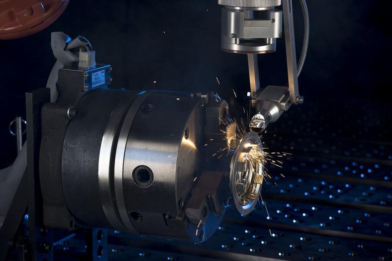 An image of laser welding on a metal part