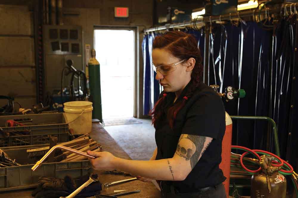 Female metal fabrication apprentice 
