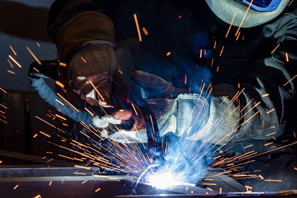 A person performs MIG welding.