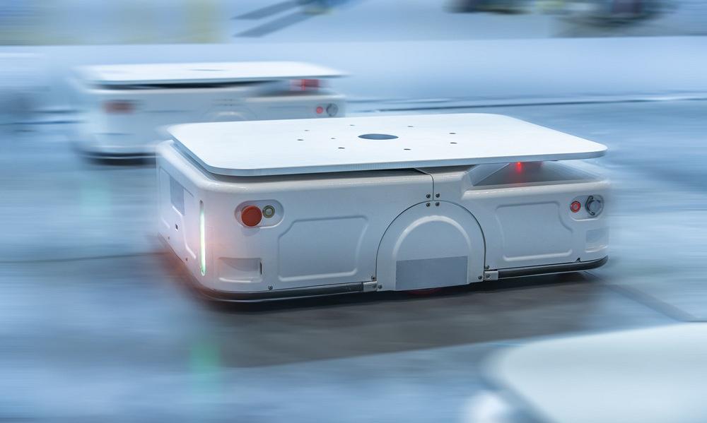 Two autonomous mile robots move across a factory floor.